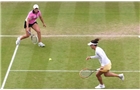 BIRMINGHAM, ENGLAND - JUNE 14:  Casey Dellacqua (R) and Ashleigh Barty (L) of Australia in action against Caroline Garcia of France and Shuai Zhang of China on day six of the Aegon Classic at Edgbaston Priory Club on June 13, 2014 in Birmingham, England. (Photo by Tom Dulat/Getty Images)